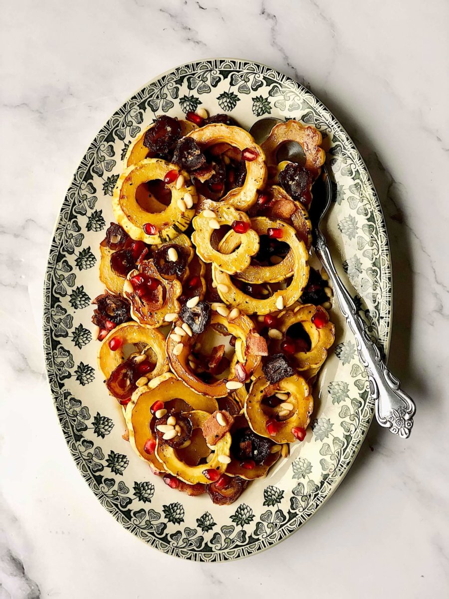 This is a picture of rounds of delicata squash with dates and pine nuts and bacon