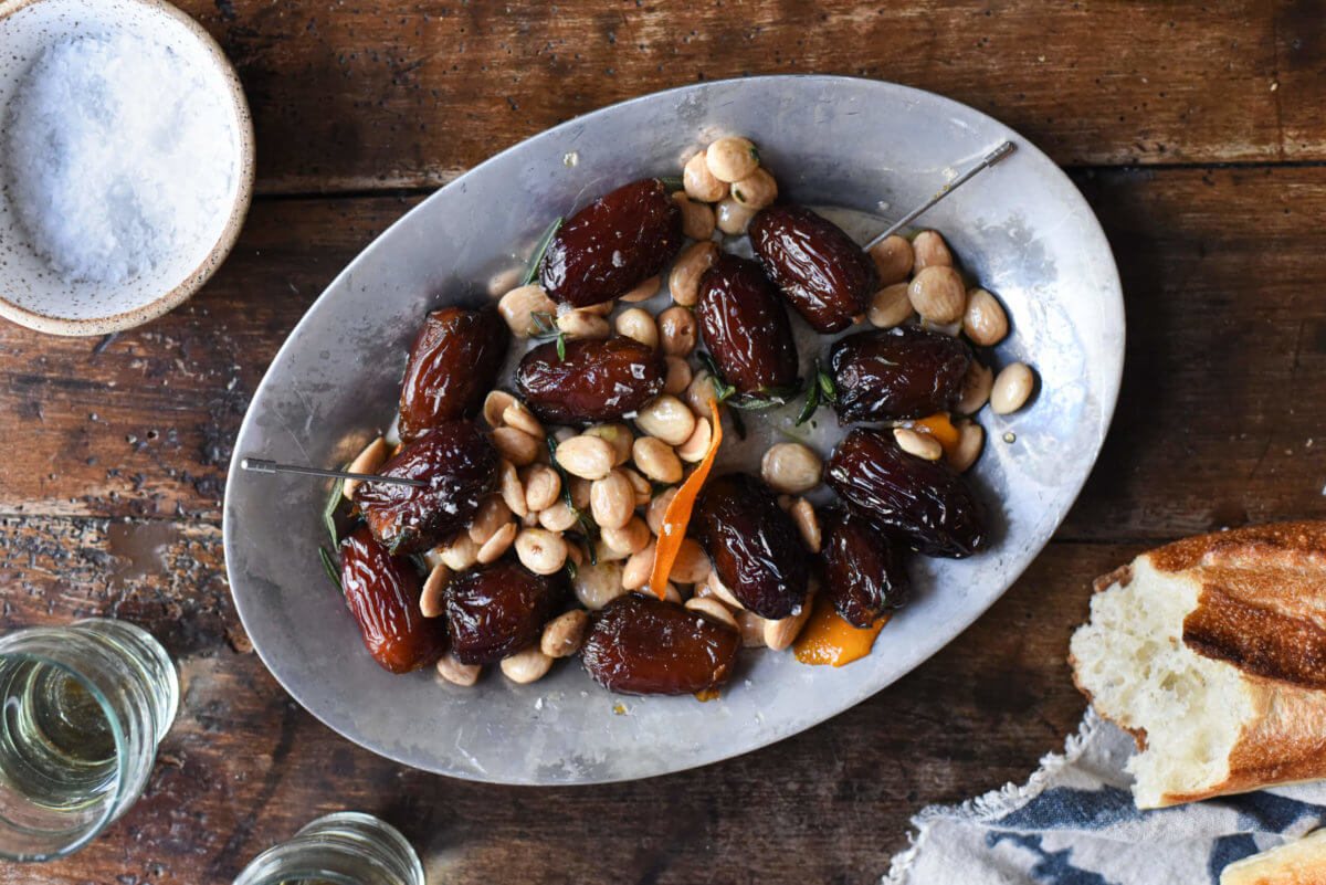a platter of dates with almonds and orange zest